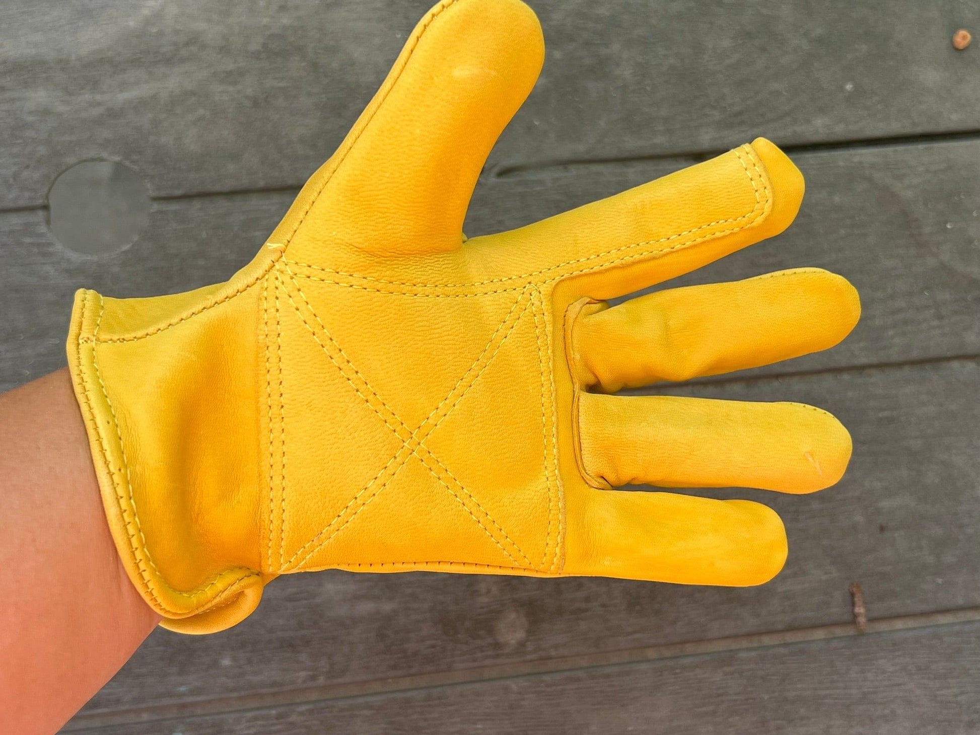 Close-up of Golden Stag 707 goatskin leather gloves showing reinforced stitching and ergonomic keystone thumb for enhanced durability.
